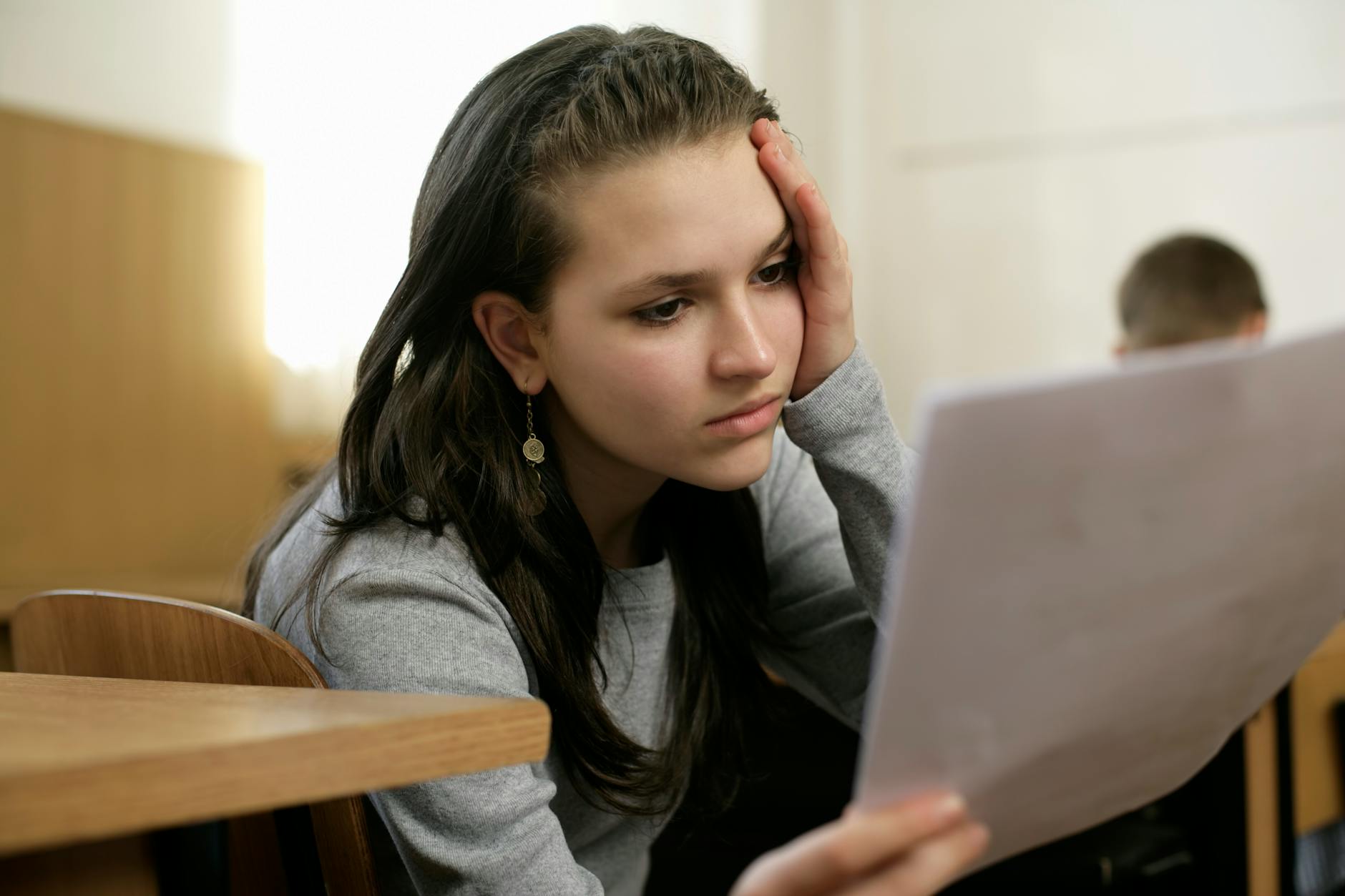 young woman holding and reading a document