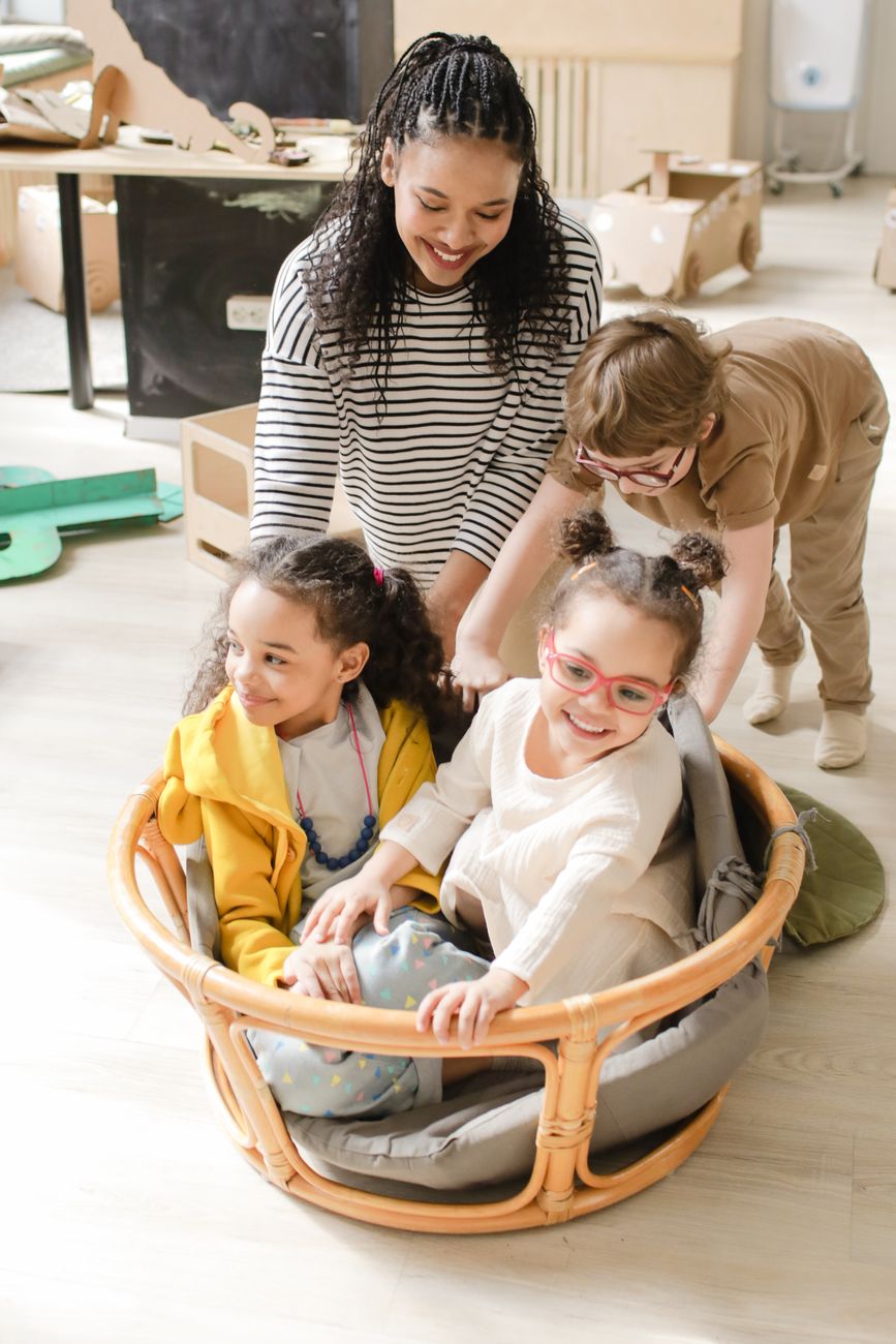 Early years practitioner engaging with nursery children