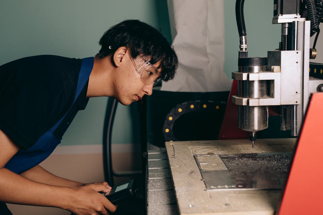 Young apprentice working on technical equipment